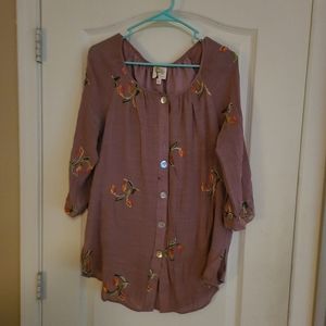 Womans blouse with embroidery button down front and long sleeves.